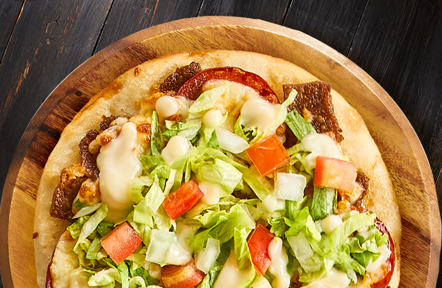 Super Donair with donair meat, pepperoni, mozzarella, lettuce, onions, tomatoes and donair sauce