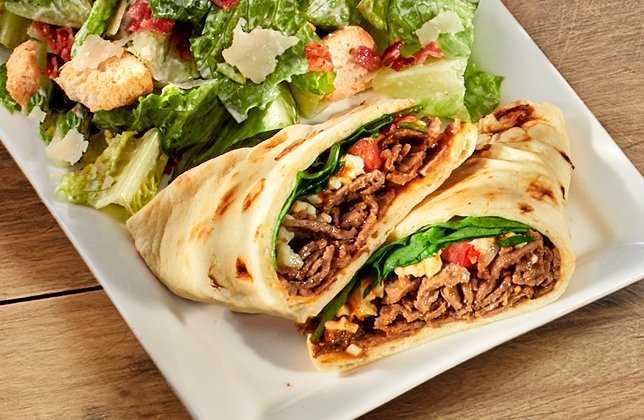 Steak and cheese naanwich with peppers, onions, tomatoes, spinach, mozzarella and chipotle mayo