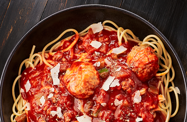 Spaghetti with Italian meatballs, seasoned meat sauce, vegetables and Parmesan
