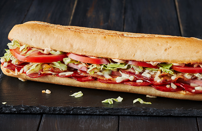 Italian Delight sandwich with pepperoni, ham, bacon, salami, mozzarella, lettuce, tomato and chipotle mayo