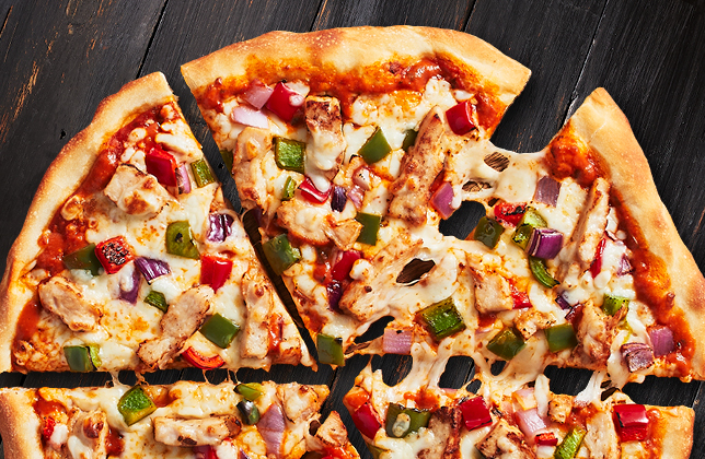 Butter chicken pizza with grilled chicken, peppers, red onion, mozzarella and butter chicken sauce