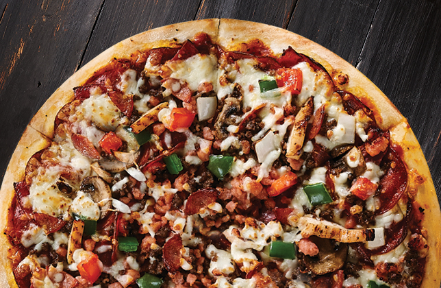 Ultimate pizza with pepperoni, salami, chicken, beef, sausage, bacon, vegetables and mozzarella