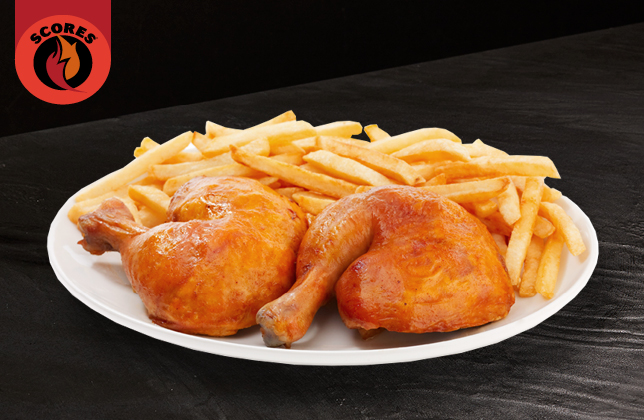 Two rotisserie chicken legs served with coleslaw, BBQ sauce and a choice of side
