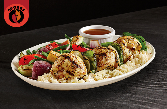 Traditional chicken brochettes with marinated chicken breast served over rice