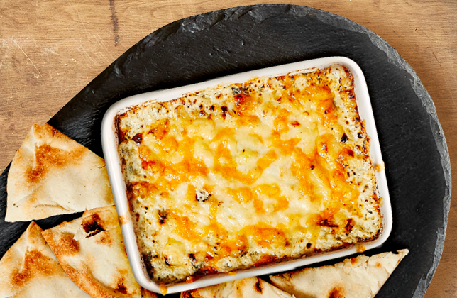 Warm creamy spinach dip served with naan bread