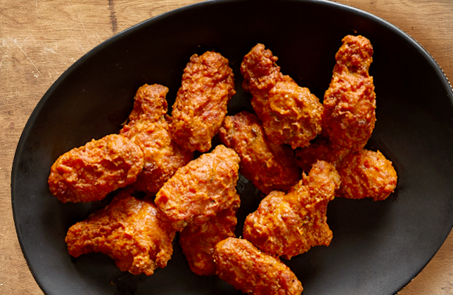 Chicken wings with sauce, available boneless or lightly breaded